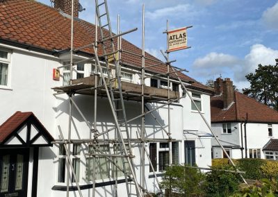 Detached property with scaffolding to repair guttering.